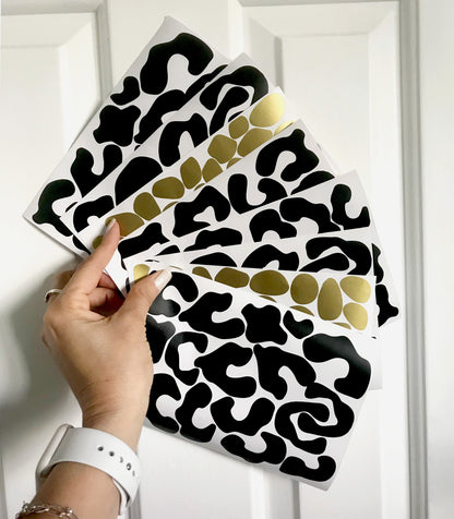 woman hand holding leopard wall stickers gold and black colours dots 