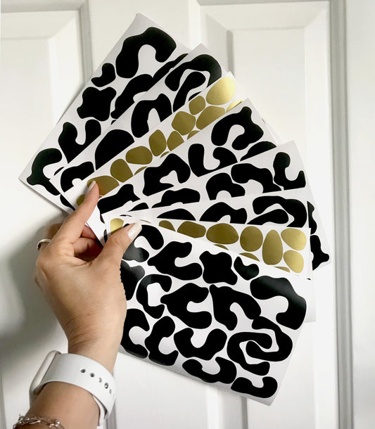 woman hand holding leopard wall stickers gold and black colours dots 