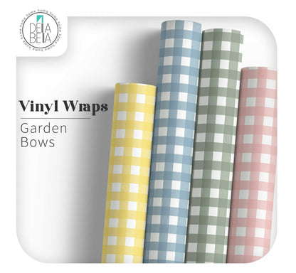 Four rolls of checkered vinyl wraps in yellow, blue, green, and pink on a white background with 'Dela Bella' branding.