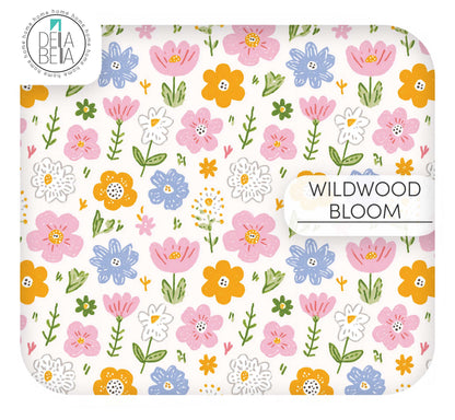 A cheerful meadow-style furniture vinyl wrap on a crisp white background. Features medium-density hand-drawn blossoms in vibrant orange, periwinkle blue, and bright pink with whimsical green leaf sprigs and stems
