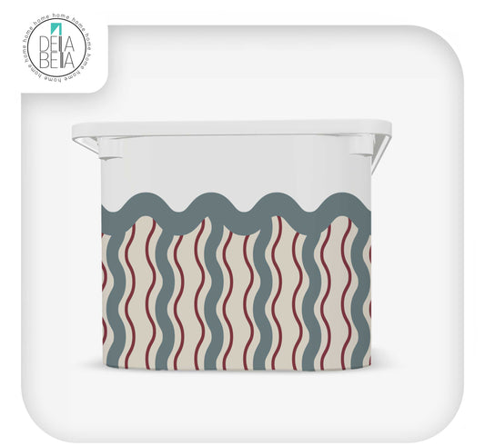 Close up of Della Bella white vinyl sticker for IKEA Trofast bin, showing vintage circus tent pattern with red and blue waves."