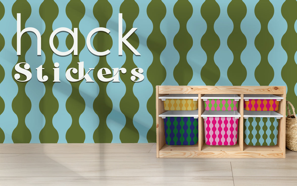 An IKEA Trofast storage unit customised with a variety of colourful retro stickers, illustrating the concept of IKEA Hacks from Della Bella Home