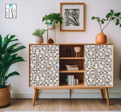 A room setting showing a sideboard with Japandi style vinyl wrapping featuring geometric patterns of arches and circles, with plants and decorative items on and around it.