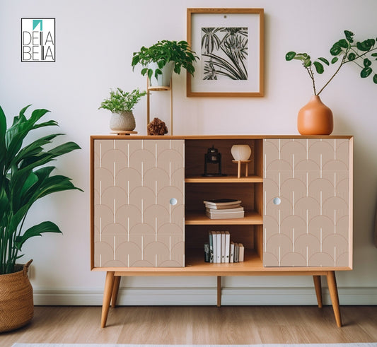 A vinyl wrap with a boho arch design applied to a wooden furniture piece, possibly a cabinet or sideboard, in a room with other decor.