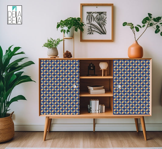 A vinyl wrap with a geometric pattern featuring blue and white colors applied to kitchen cabinets and a fridge, contributing to a mid-century modern aesthetic in a home interior setting.