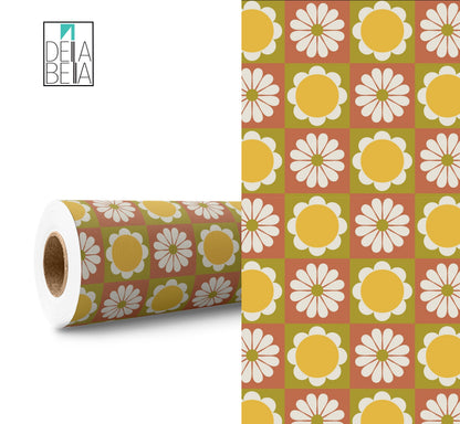 A roll of vinyl wrap with a retro daisy pattern, alongside a section unrolled to show the design. The pattern features yellow and white flowers on a green background.