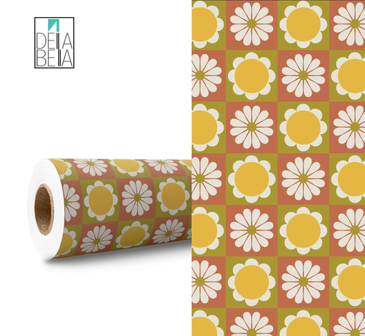 A roll of vinyl wrap with a retro daisy pattern, alongside a section unrolled to show the design. The pattern features yellow and white flowers on a green background.